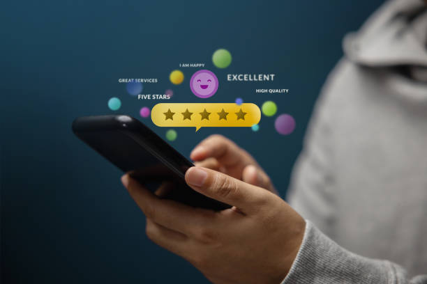 Customer Experiences Concept. Happy Client Using Smartphone to Review Five Star Rating for Online Satisfaction Surveys. Positive Feedback on Mobile Phone stock photo