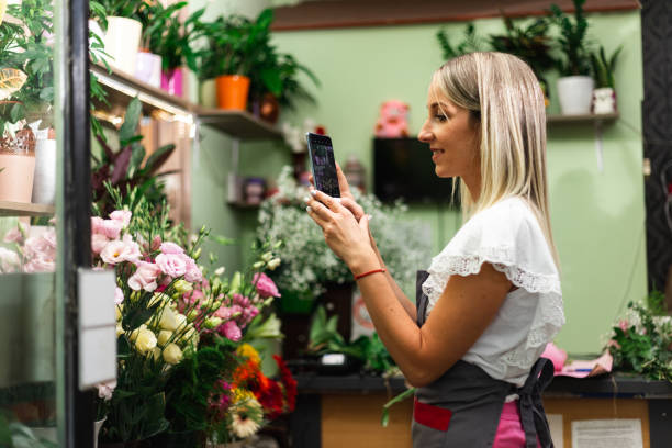 istock Close up of a young female using a smartphonea while working in a flower shop 1410451689