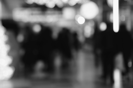 Blurred background. People in the mall. Black and white photo.