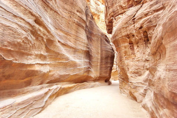 Petra (Jordan) - footpath between the erosied rocks to the Al-Khazneh. stock photo