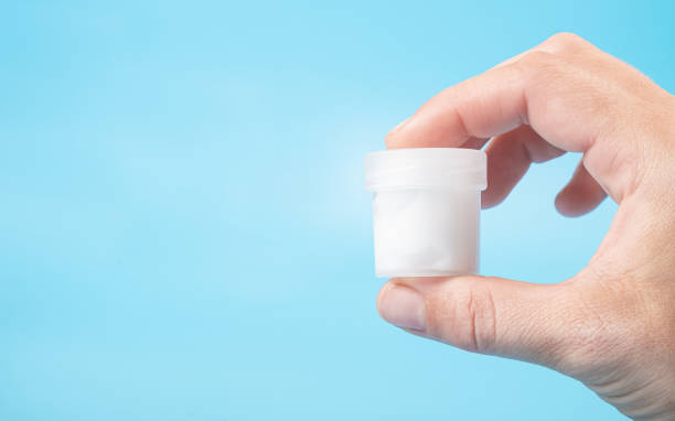istock sperm donation concept, a test tube with a white liquid in hand copy space  on a blue background 1410457700
