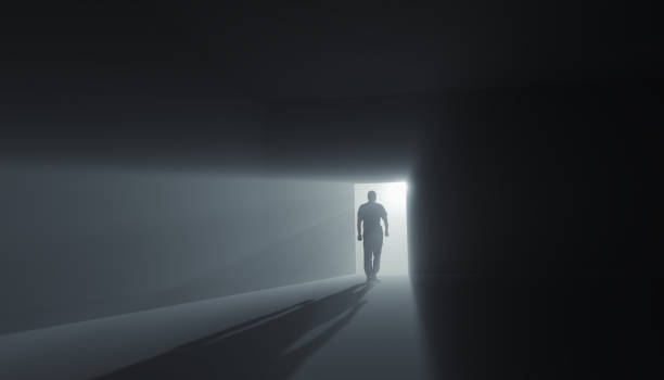 istock Go into the light concept. A man goes into the light from the heaven doors in a minimalist room - the concept of leaving the world 1410457759