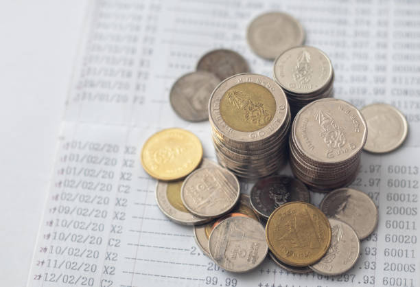 istock Coins are placed on the account book. money saving concept 1410460732