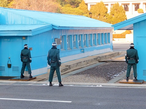 Panmunjom, Korea - November 30, 2013: This is a North Korean soldier as seen from the South Korea side of Panmunjom.Around the Panmunjom, it has become a (JSA) Joint Security Area of the North-South bilateral. Conference hall of the military ceasefire committee will be constructed, UN soldiers and Korean army soldiers, North Korea army soldiers ,They are guarding face to face across the border.