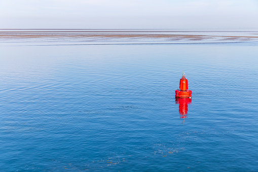 Red buoy in the sea near by Terschelling, the Netherlands
