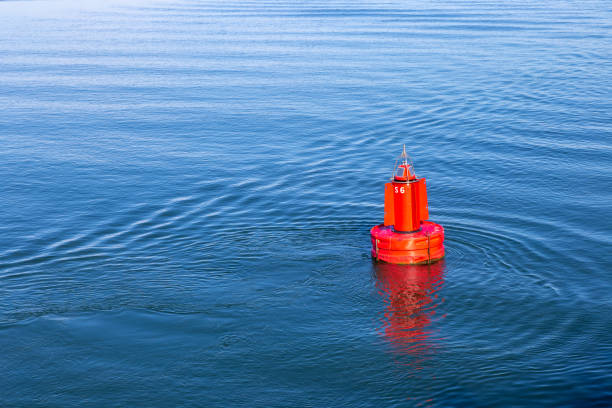 Red buoy in the sea near by Terschelling, the Netherlands Red buoy in the sea near by Terschelling, the Netherlands channel marker stock pictures, royalty-free photos & images