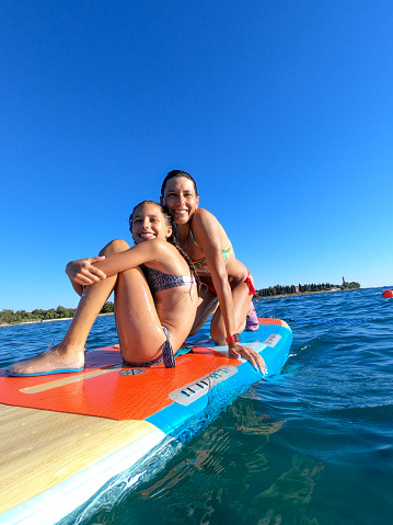 Mother and daughter on Paddle board