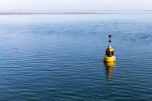 Yellow buoy in the sea near by Terschelling, the Netherlands