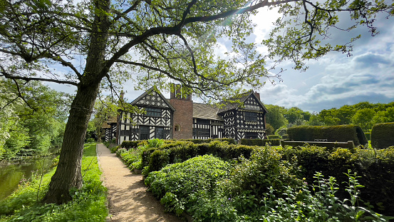 Beautiful and ancient Little Moreton Hall, nestling in the countryside near Congleton in Cheshire, United Kingdom.Its almost a miracle that the Hall is standing since there appears to be not a straight ceiling, wall or floor in the whole 500 years old structure.Under the care of the National Trust, this Tudor Mansion simply oozes history and atmosphere, and is a delightful place to admire its higgledy-piggledy charms which include a moat and lovely gardens.