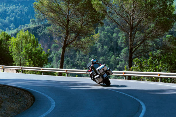 istock Biker riding a motorcycle along a curve 1410469148