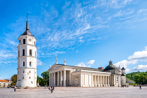 Vilnius, Lithuania - August 10, 2019:  The main church and the most important square in Lithuania - in the state capital Vilnius: the Cathedral Basilica of St Stanislaus and St Ladislaus with the belfry in the Cathedral Square in the morning with copy space