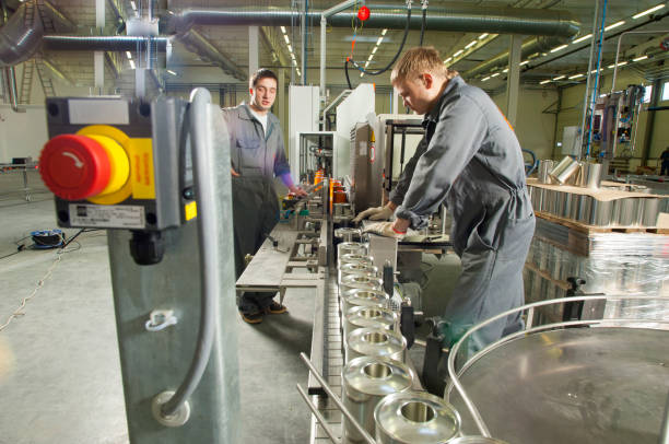 istock Two young workers working on an assembly line at a paint and varnish factory 1410470330