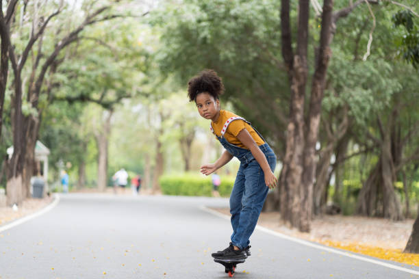 istock Girl playing on skateboard. 1410476060