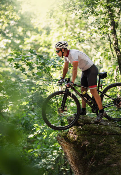 istock mountain biker riding his bike throught the mountain 1410479237