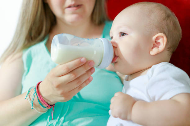 istock Baby boy drinking milk from bottle 1410479312