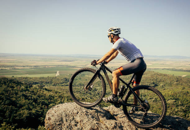 istock mountain biker riding his bike throught the mountain 1410479337