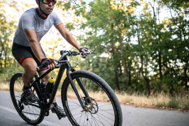 istock mountain biker riding his bike throught the mountain 1410479352