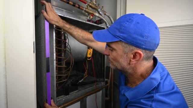 HVAC Technician Installing a Furnace Filter