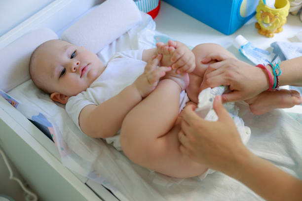 istock Cute baby in bedroom getting diaper changed 1410480454