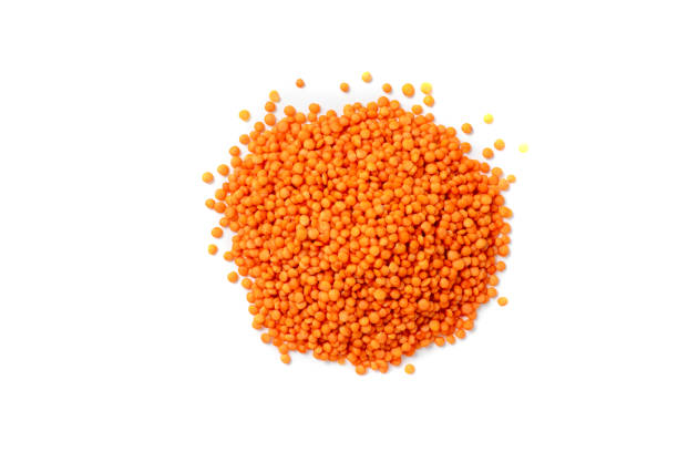 istock Dry red lentils on a white background isolate. Red lentil grits. Red lentils pile isolated. Dry orange lentil grains, heap of dal, raw daal, dhal, masoor, Lens culinaris or Lens esculenta on white background 1410481133