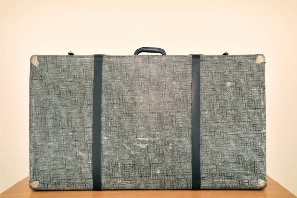 istock Vintage suitcase on the brown wooden table 1410482453