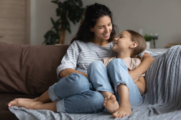 istock Mother little daughter share secrets having warm conversation at home 1410485224