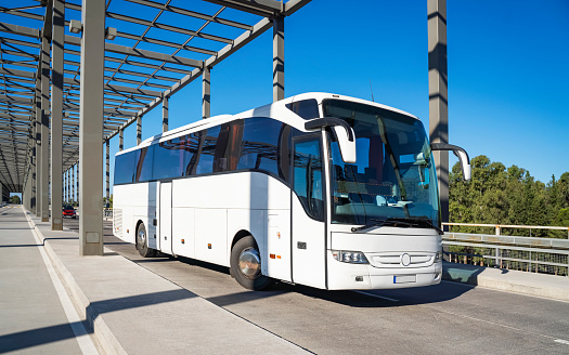 White Tourist bus on the way in the international public airport Dalaman, Turkey. travel company bus greets tourists at the airport to take to the hotel