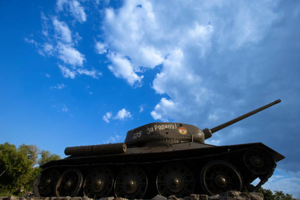 A breathtaking WWII tank monument blanketed in a thick layer of snow, set against a striking modern urban backdrop