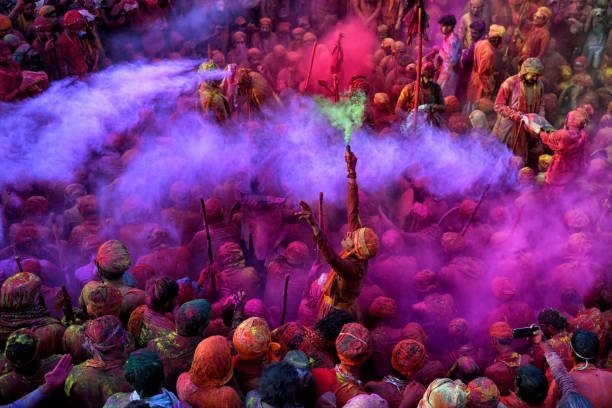 Hindu devotees play with colourful powders (Gulal) at Radharani Temple of Nandgaon in Mathura during the Holi festival. Holi Festival of India is one of the biggest colourful celebration in India as many Tourists and devotees gather to observe this colourful event. Marking the beginning of Spring, the festival celebrates the divine love of Radha and Krishna and represents the victory of good over evil.