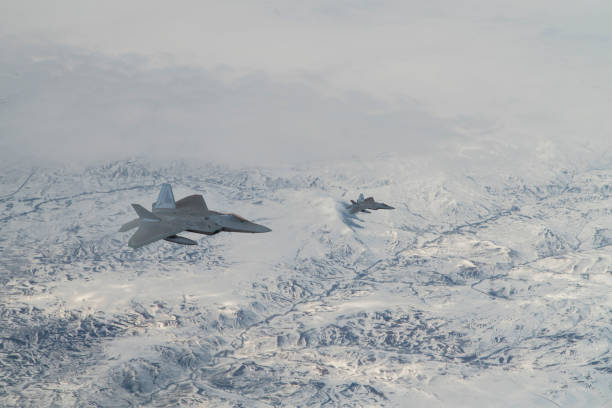istock Jet aircrafts flying over snowcapped mountains. 1410489271