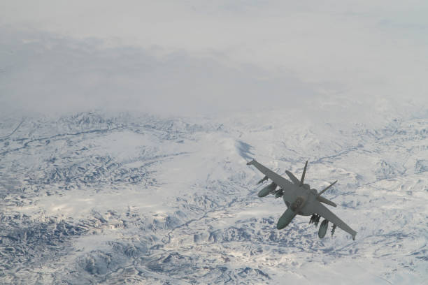 istock Jet aircrafts flying over snowcapped mountains. 1410489339