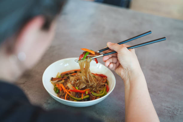 japchae is a traditional korean food which is mixed dish of  stir-fried vegetables - bean vegetarian food stir fried carrot imagens e fotografias de stock