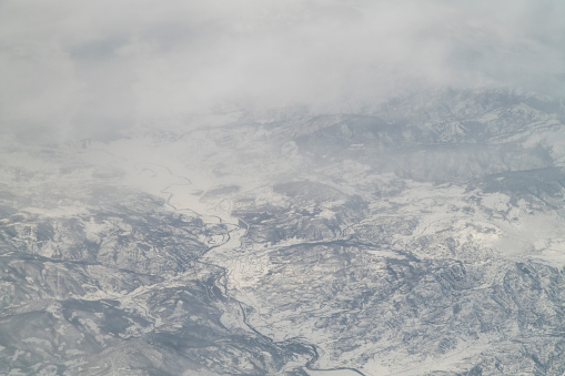 Clouds above the stratosphere from airplane window.