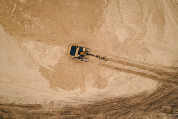 istock Aerial top down view of an excavator loading sand into a dump truck 1410494808