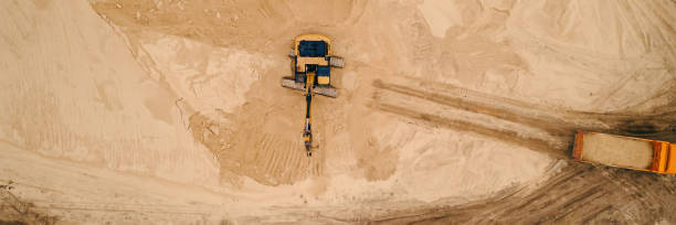 istock Excavator loading sand into a dump truck in opencast sand quarry 1410494862