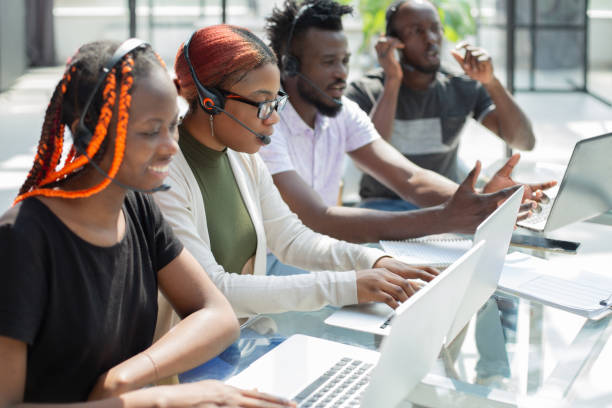 istock Group of african people working on laptops in a call centre 1410495667
