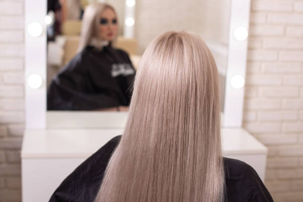 istock Female back with long, straight, blonde hair 1410497145