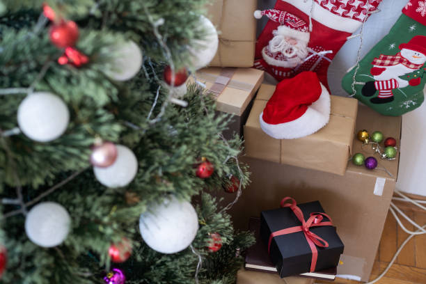istock Beautiful Christmas tree and gift boxes in room. Space for text. 1410501057