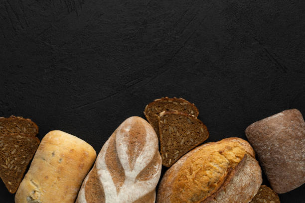 istock Different bread, gluten free, rye, multigrain on a black background 1410504696