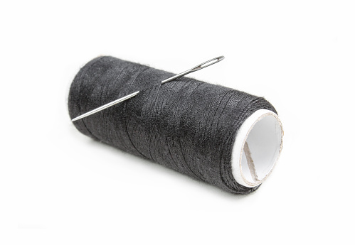 Needle and black thread isolated on white background.