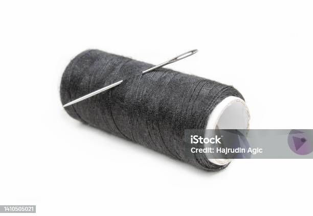Needle And Black Thread Isolated On White Background Stock Photo