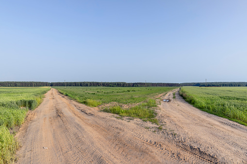 unpaved highway in rural areas, part of the road for cars without asphalt in the summer