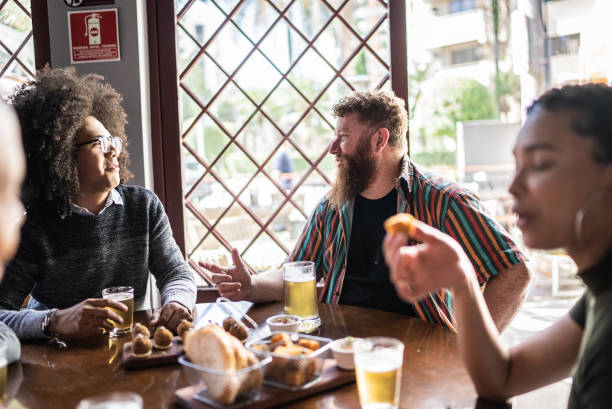 istock Friends drinking and eating at a bar 1410505232