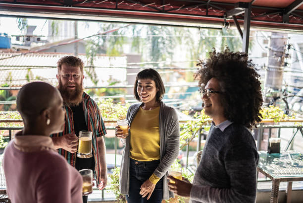 istock Friends talking and drinking beer at the bar 1410506334