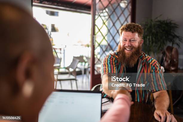 Mature man shaking hands in a business meeting in a restaurant