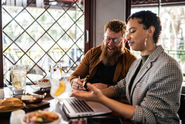 istock Coworkers using laptop doing a meeting in a restaurant 1410506671