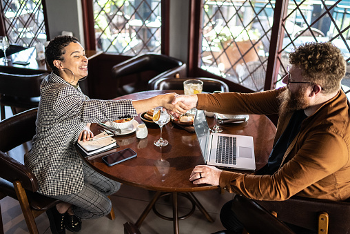 Business people shaking hands in a restaurant