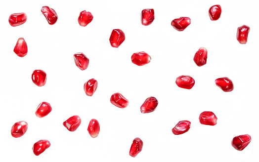 Pomegranate seeds isolated on white background. Fruit Wallpaper background