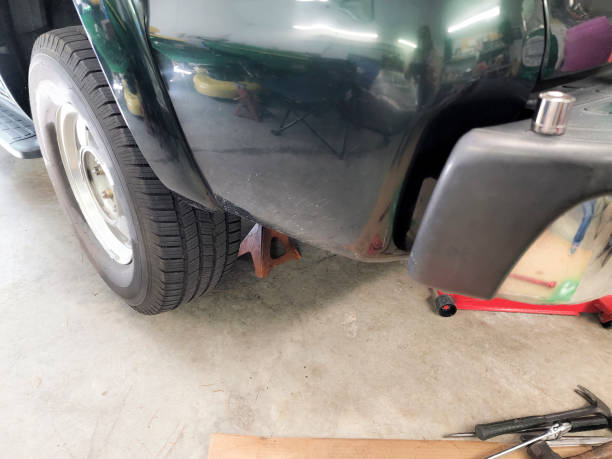 istock LV Vehicle jacked up and stabilized while mechanic changes the shocks. 1410507953