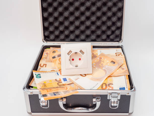 The electrical outlet is in a suitcase with money. The electrical outlet is in a suitcase with money. Electricity cost and expensive energy concept. gold ira kit stock pictures, royalty-free photos & images